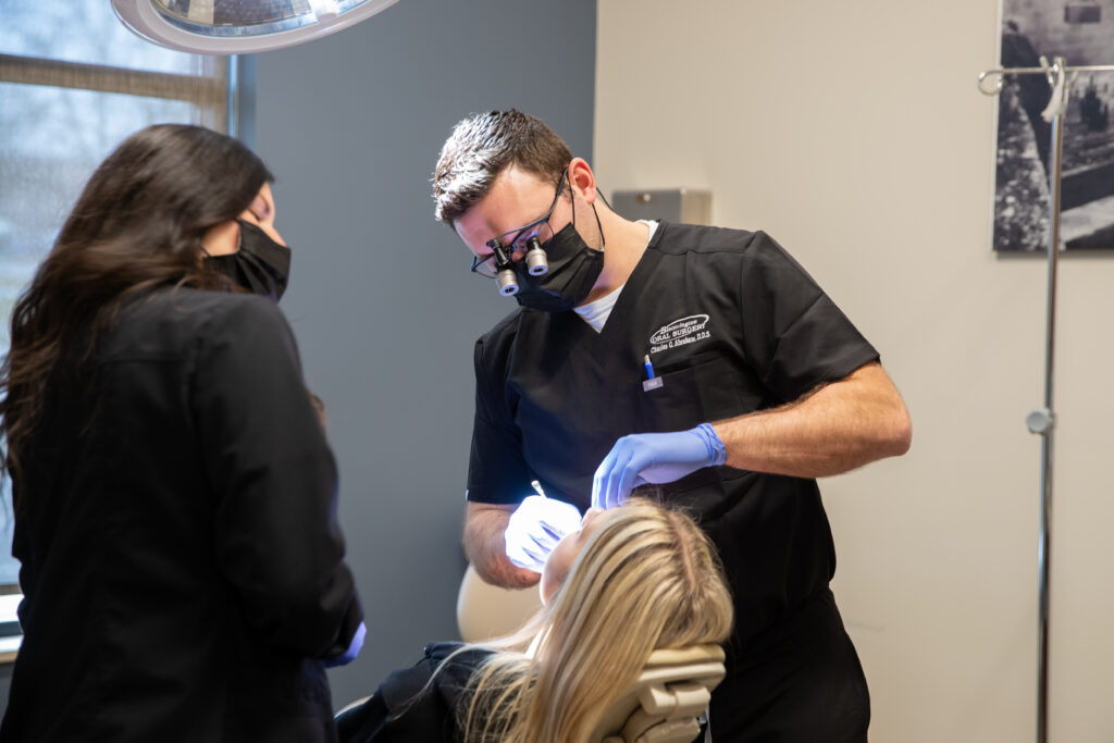Dr Charles Abraham an oral surgeon at Bloomington Oral Surgery working with a patient