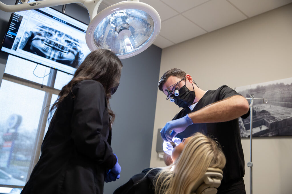 Dr Charles Abraham an oral surgeon at Bloomington Oral Surgery working on a patient