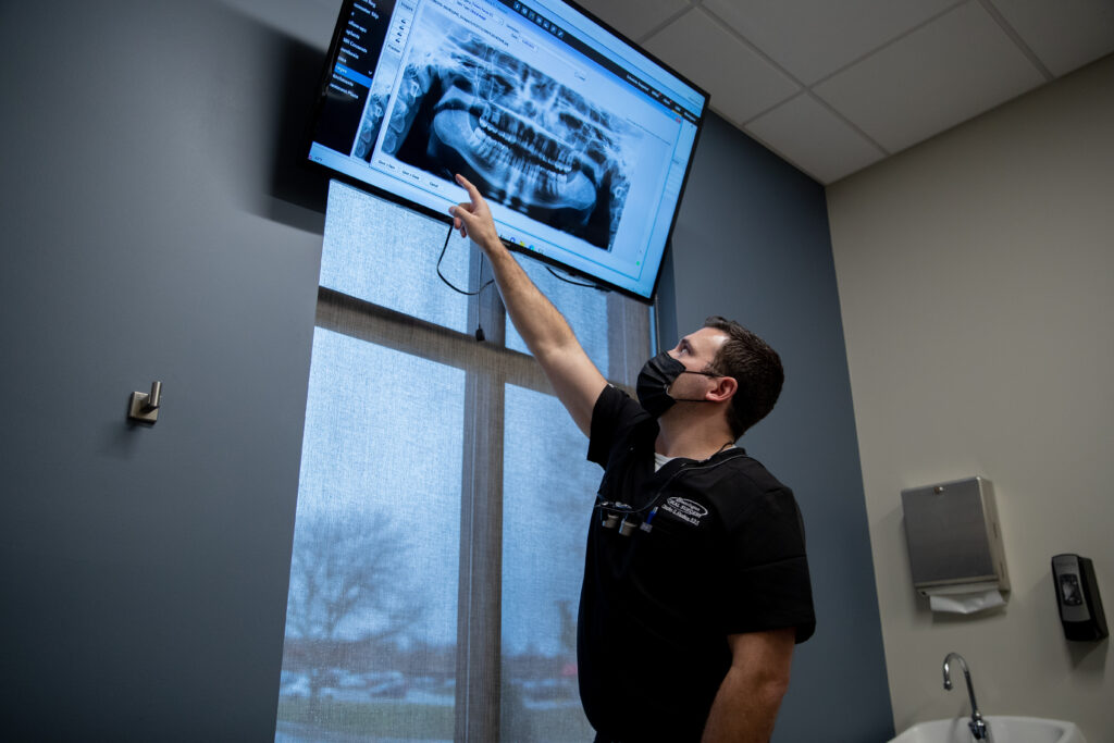 Dr Charles Abraham an oral surgeon at Bloomington Oral Surgery looking at a xray